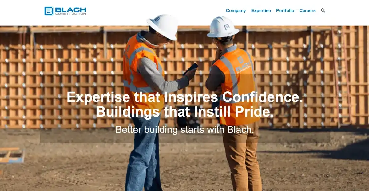 Blach Construction website showing 2 employees discussing a construction project
