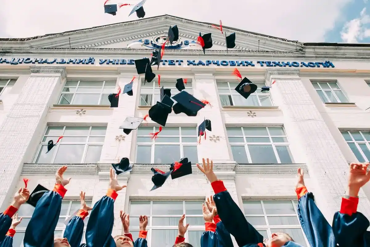 A group of college students celebrating after graduating
