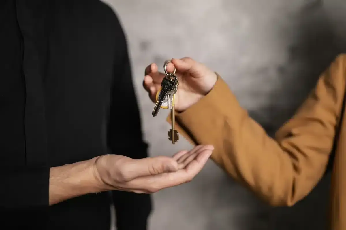 Landlord giving keys to new tenant