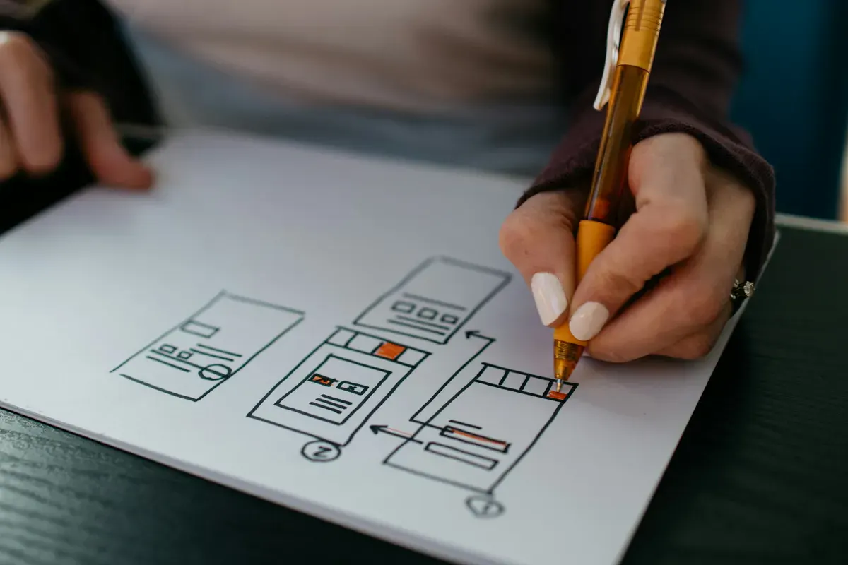 website mockup being drawn on a white piece of paper