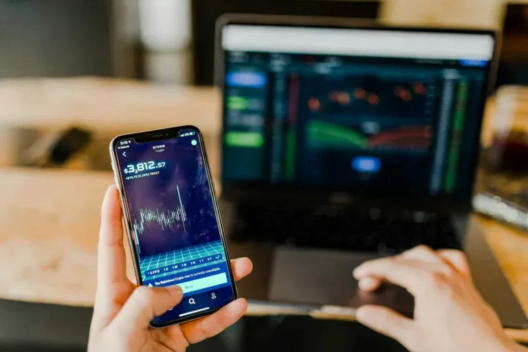 a hand holding a cellphone browsing a fintech website app