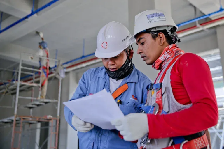 construction workers reading the project objectives