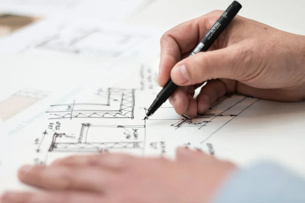 Architect fixing plans with a black marker