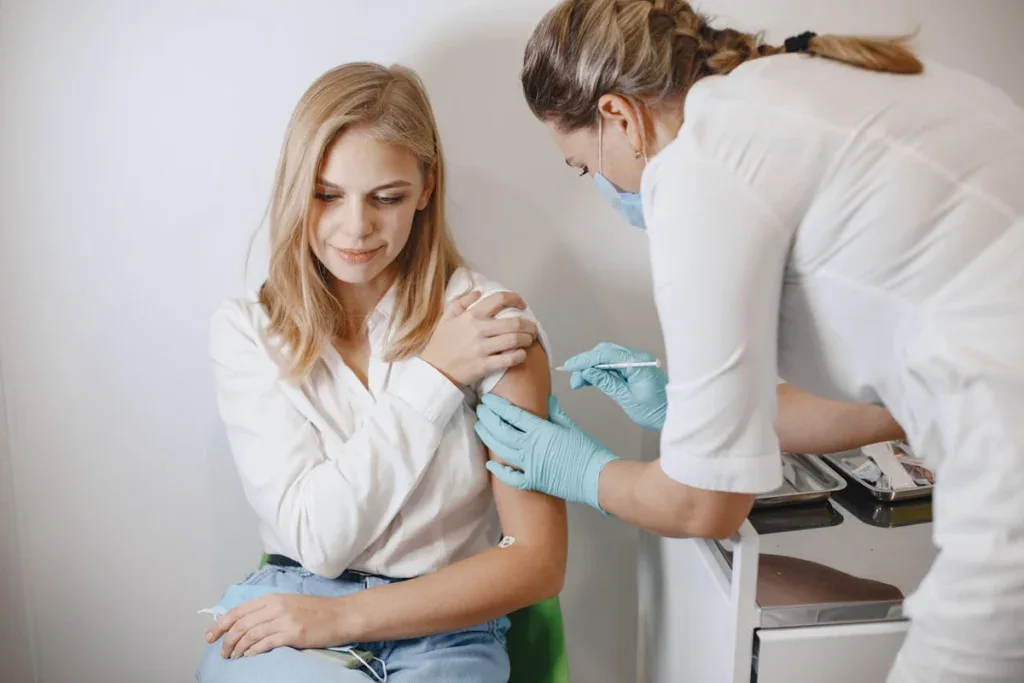 Nurse taking blood sample from a blonde woman