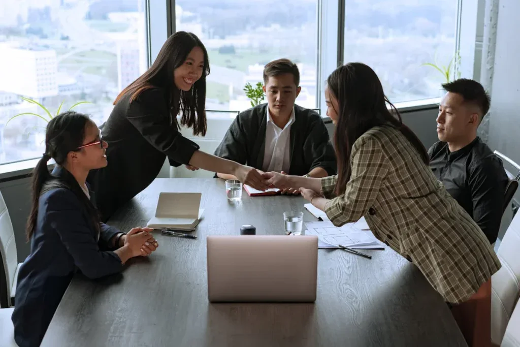 A group of people sitting at a table discussing