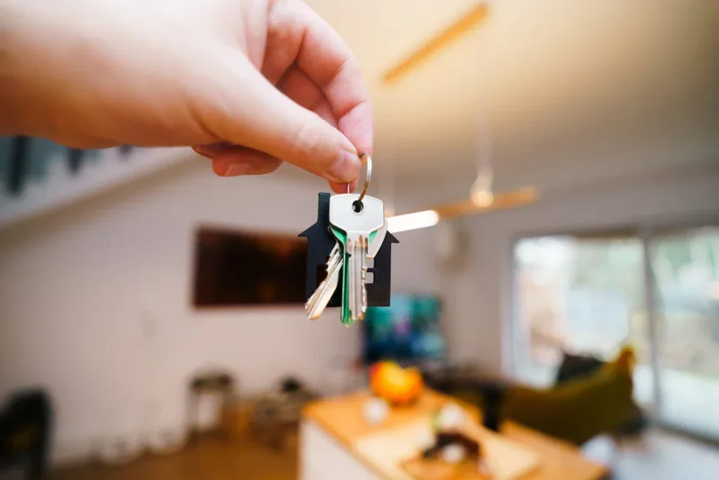 Woman hand holding keys in house