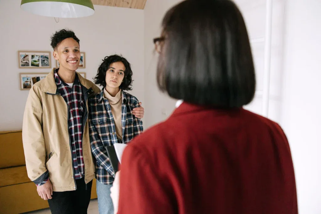 Real estate agent with a couple explaining about online payments for tenants