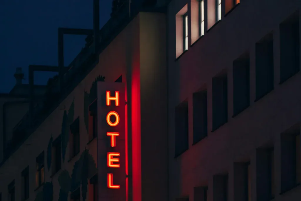Red hotel sign lit up at night