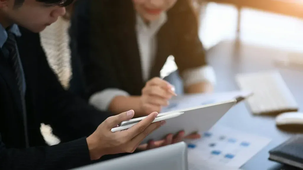 Workers reviewing secure finance websites on a tablet