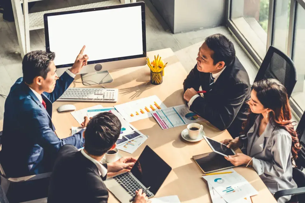 Marketers working on ideas while sitting around a table