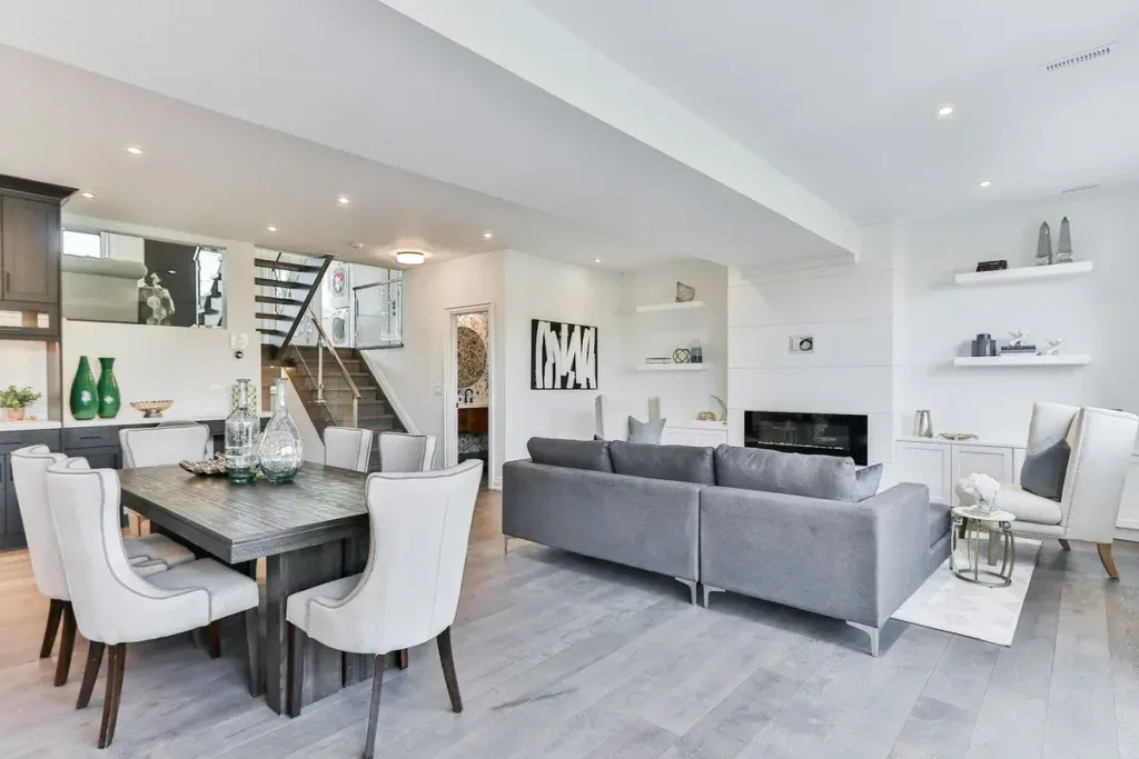 Modern apartment interior with white walls and a grey sofa